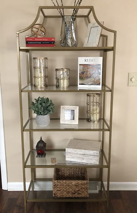 a five-shelf bookcase adorned with decor in a reviewer's living room