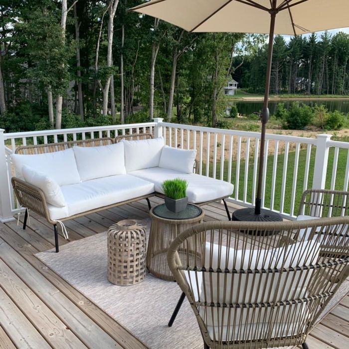 Reviewer photo of a white L-shaped sofa set on the deck.