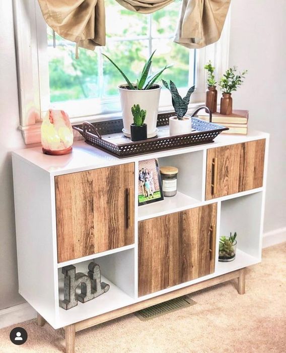 reviewer's white and brown horizontal shelf unit featuring three open sections and three enclosed compartments
