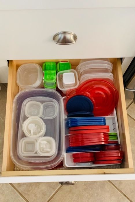 A reviewer's neatly organized drawer full of container lids.