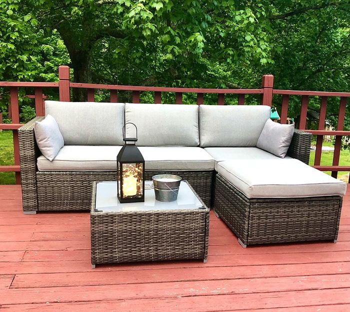 gray and wicker set arranged as a sectional with a square table