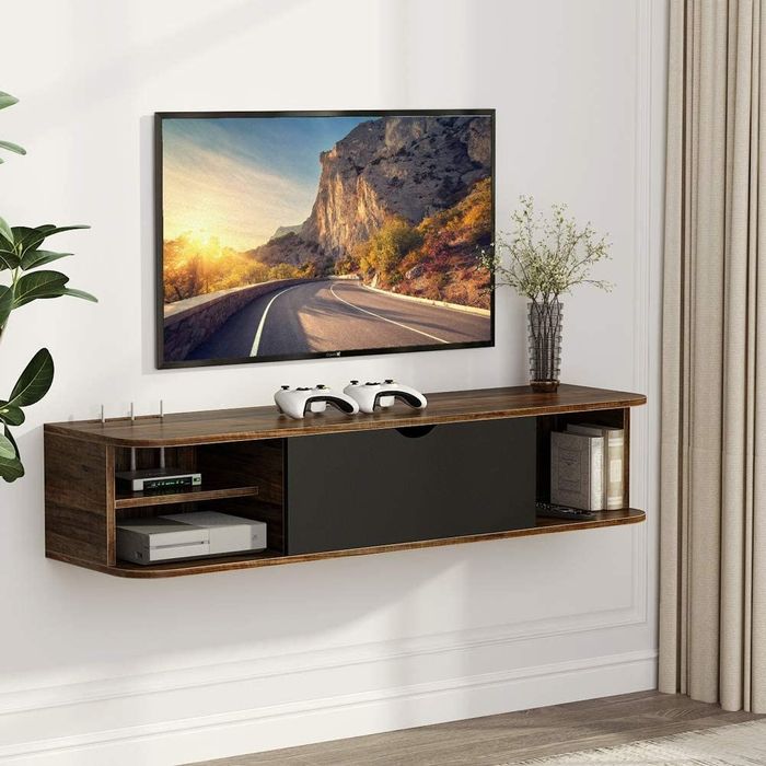 The vintage brown console with three open shelves and a closed center compartment