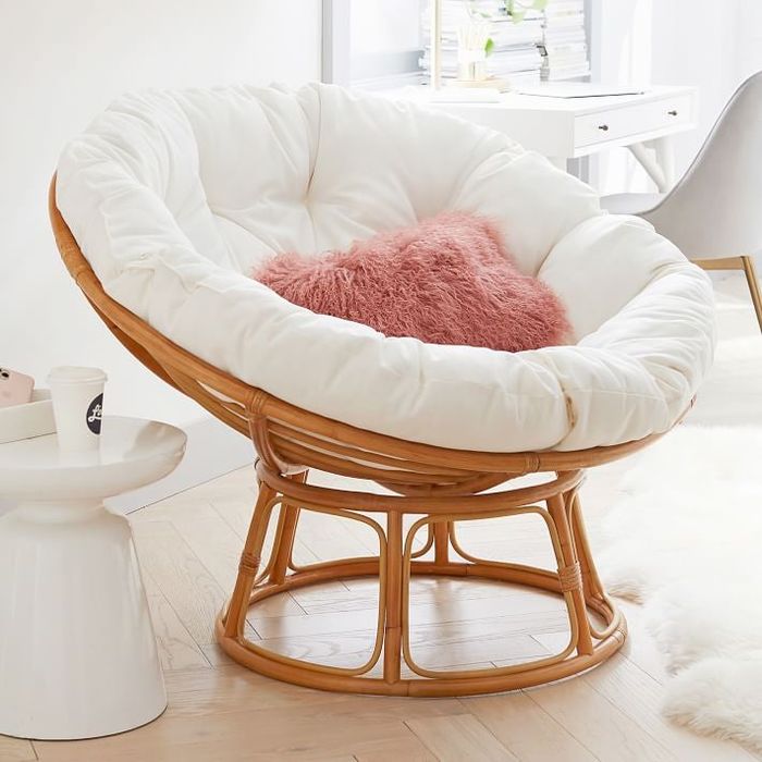 Image of a brown chair with white and pink cushions