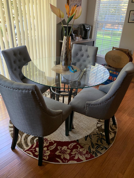 blue-gray high-back chairs with black legs positioned around a table