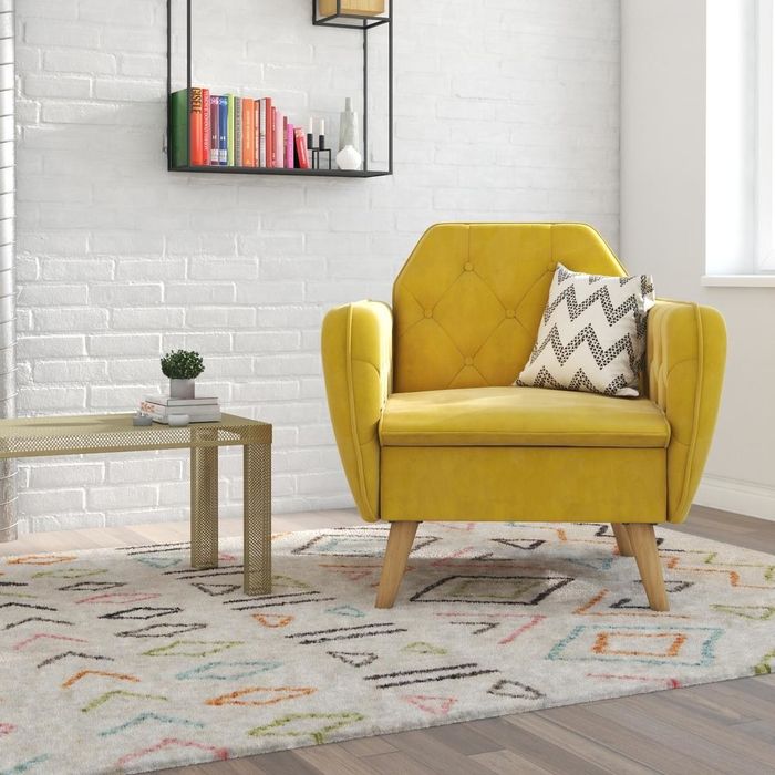 a tufted chair in a vibrant mustard yellow hue