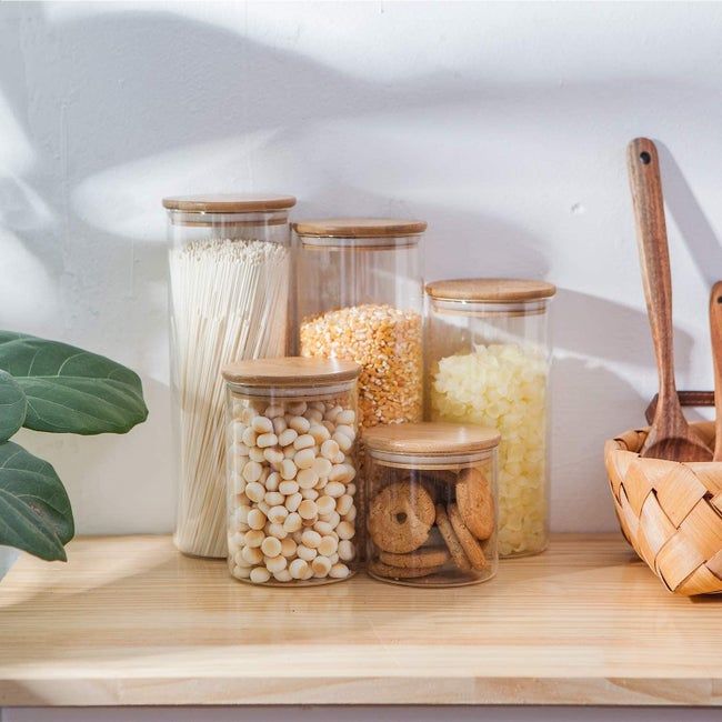 A set of five canisters in various sizes filled with snacks