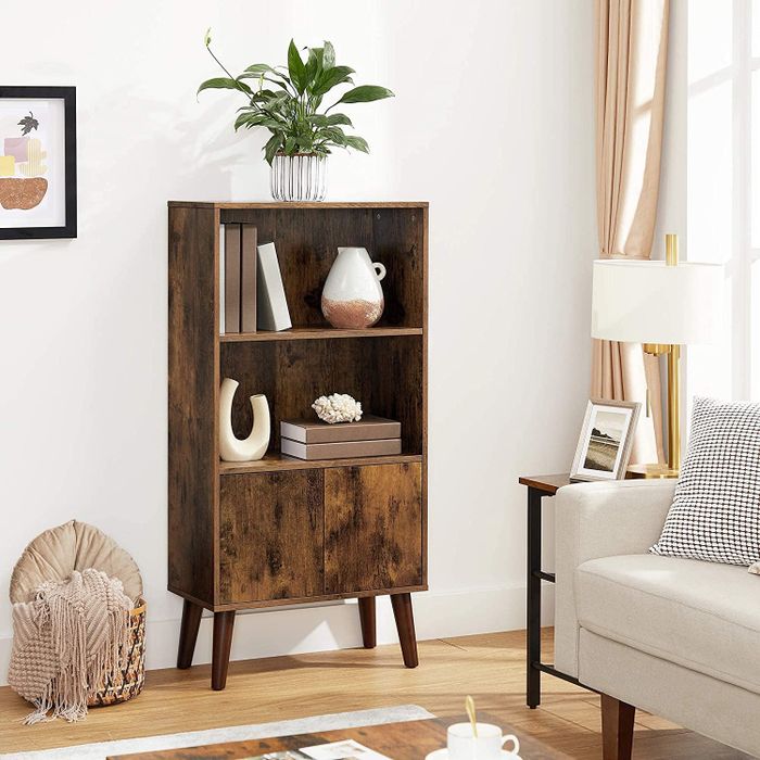 A dark wood bookcase unit positioned in a living room