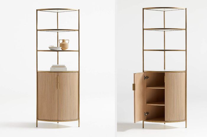 A brown wooden corner cabinet with shelves and two doors