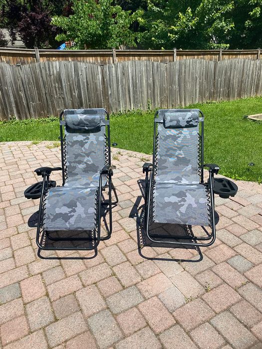 A reviewer’s two lounge chairs placed on a brick patio outside.
