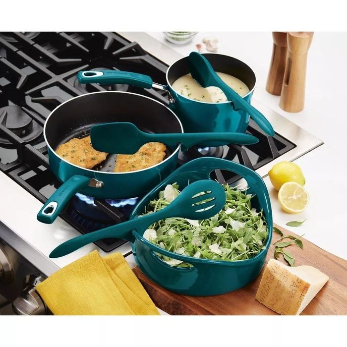 The three tools resting on different pots and pans in a kitchen setup.