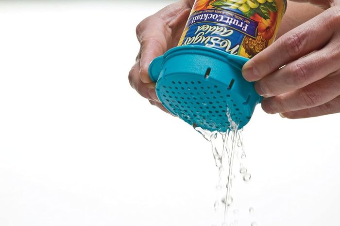 The colander placed on a can, demonstrating how it efficiently drains the liquid from inside