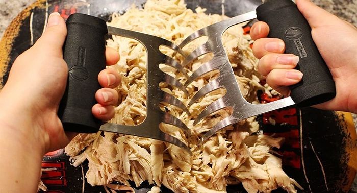 A person using the bear claws to shred meat