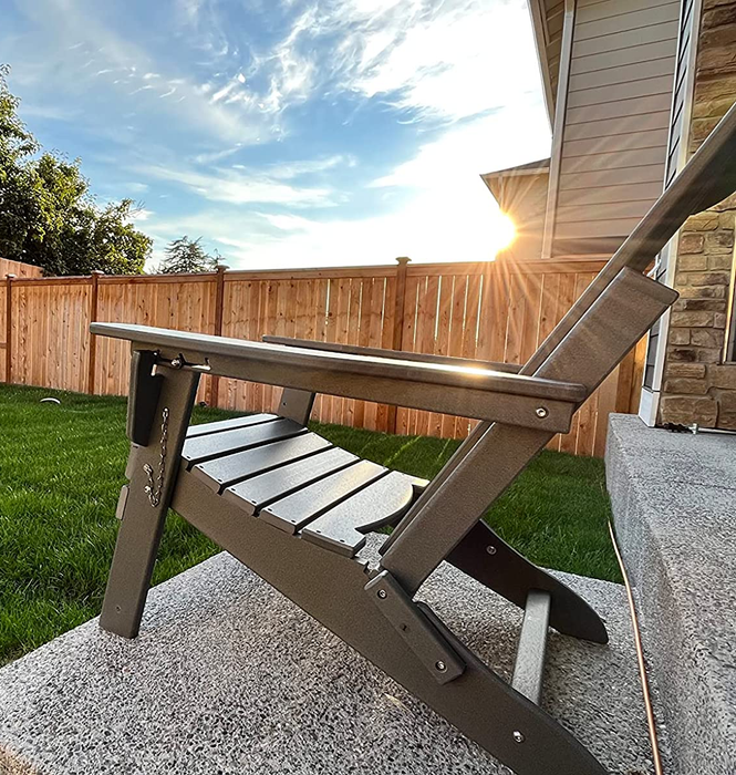 A reviewer's gray Adirondack chair placed outdoors.