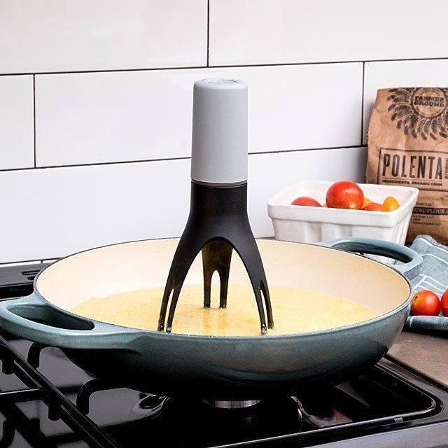 A three-pronged stirrer inside a pan