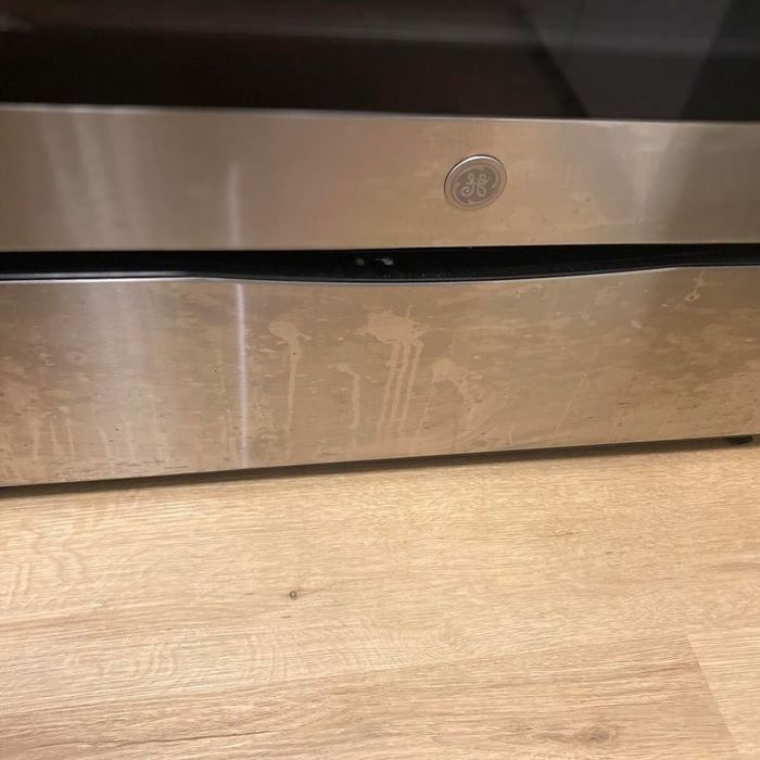 A reviewer’s photo showing a dirty stainless steel appliance before using the cleaner wipes