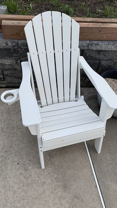 A different reviewer's white Adirondack chair, highlighting the built-in cup holder.