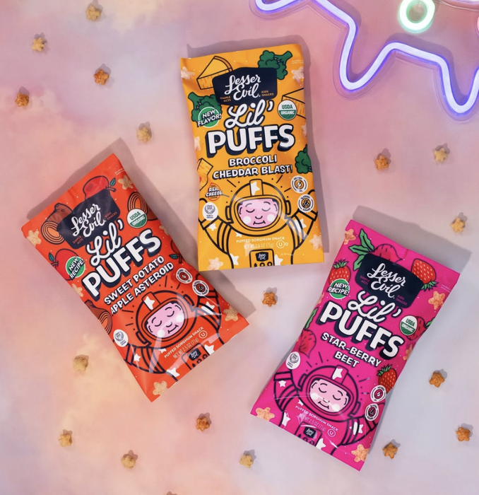 A selection of Lesser Evil Lil Puffs snacks, with playful packaging and flavors such as Sweet Potato Apple, Broccoli Cheddar, and Star Berry