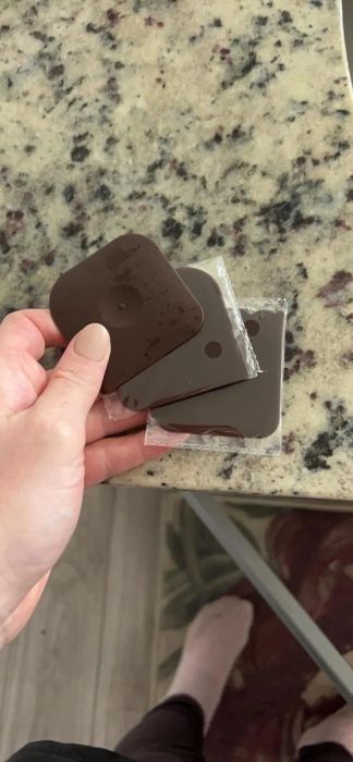 Reviewer demonstrating the dish scrapers in hand