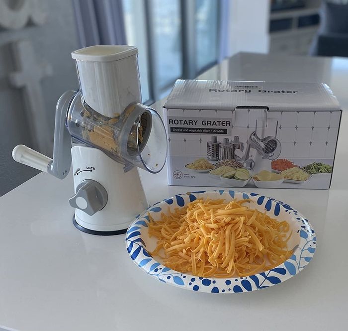 A complete cheese grater set displayed by the reviewer