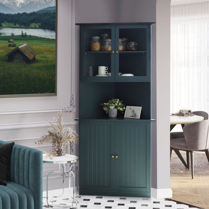 A tall teal corner cabinet featuring glass-fronted upper cabinets and solid lower cabinets