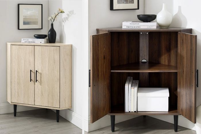 A compact corner cabinet in a room, adorned with plants on top and showcasing its interior shelves