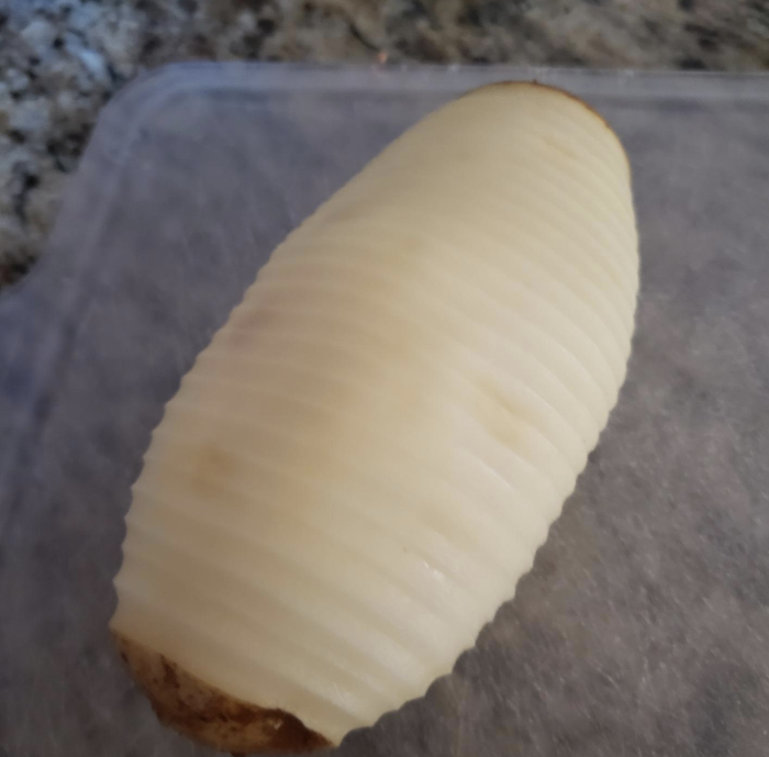 A reviewer’s perfectly peeled potato, showing the flawless result of the electric peeler