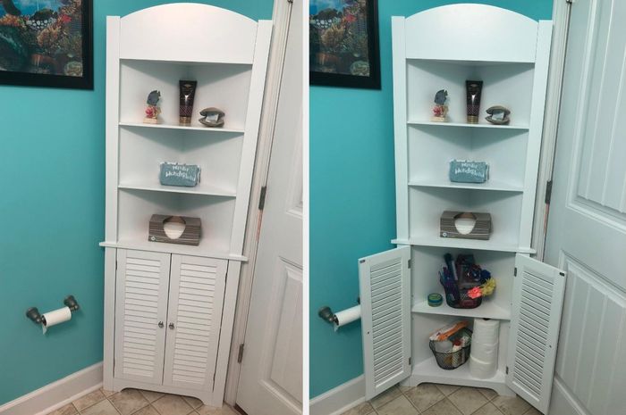 White corner cabinet in a bathroom stocked with toiletries inside the cupboard