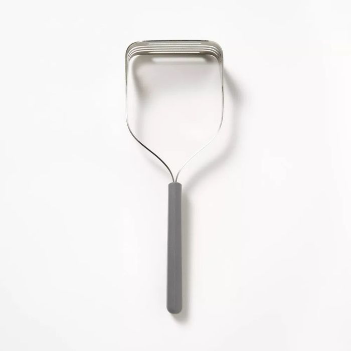 A heavy-duty stainless steel potato masher with a sturdy handle, designed for everyday kitchen tasks.