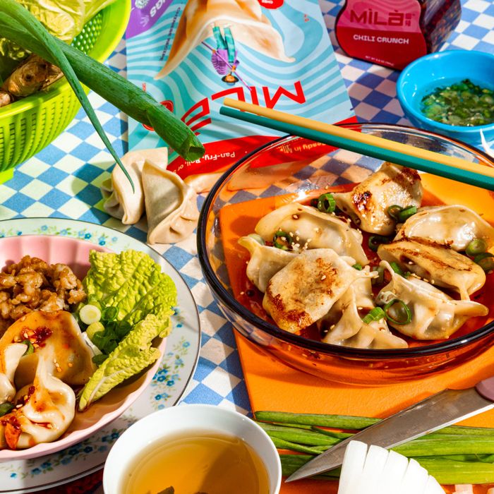 An assortment of dumplings served with chili crunch, tea, and green onions, all showcased for a shopping article