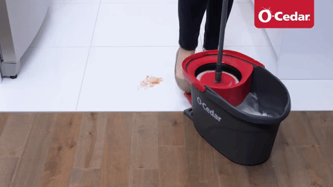 A model using the foot pedal on a water basin to wring out a small mop