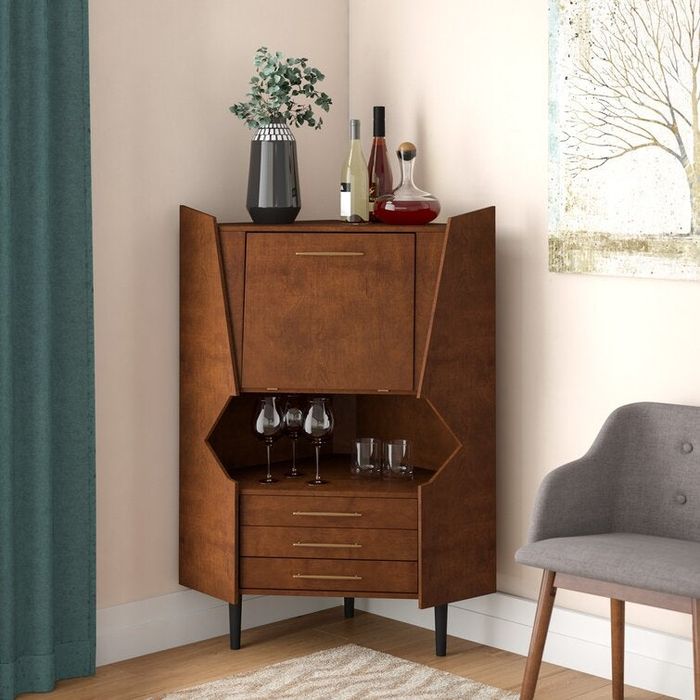 A wooden corner cabinet designed as a bar