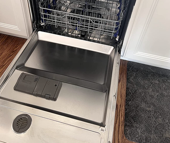 Reviewer photo showing the dishwasher stains completely removed after using the cleaning tablet