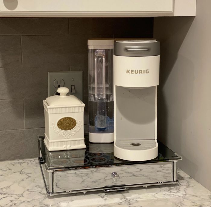 Kitchen countertop featuring a Keurig coffee maker and a decorative container