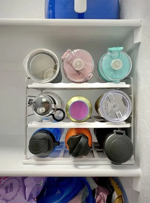 A water bottle organizer filled with vibrant bottles