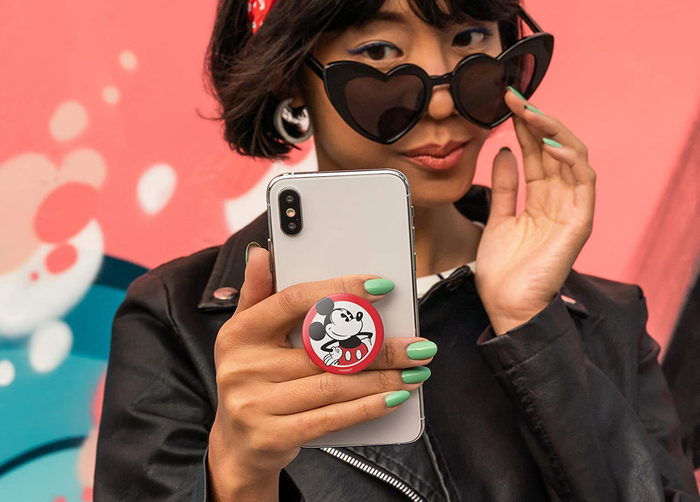 A model showcasing a classic red and black Mickey PopSocket