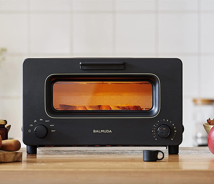 A rectangular oven glowing with an orange hue.