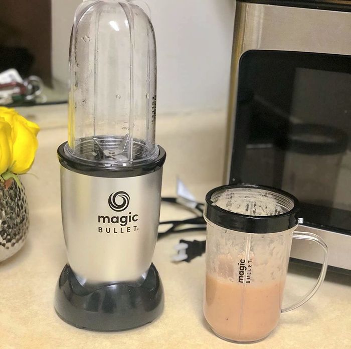 A Magic Bullet blender next to a refreshing smoothie.