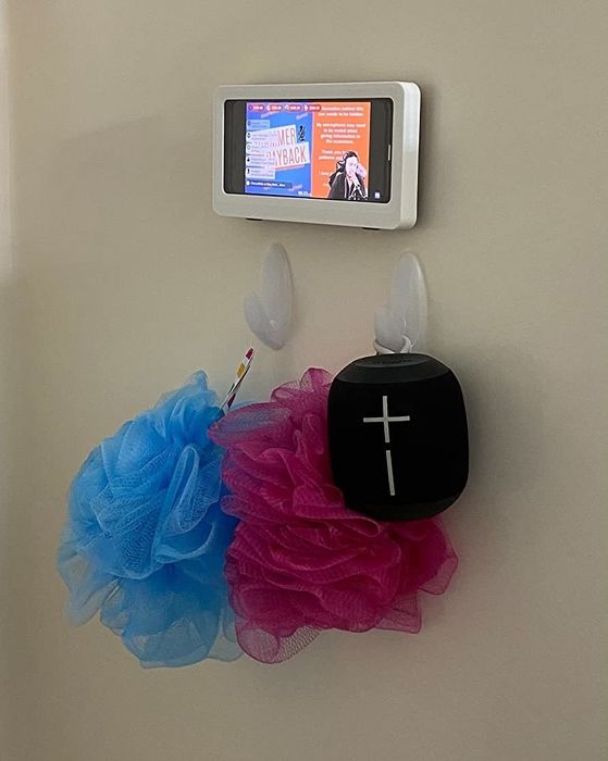 A customer photo showing the phone holder with a cell phone inside it, placed in the shower