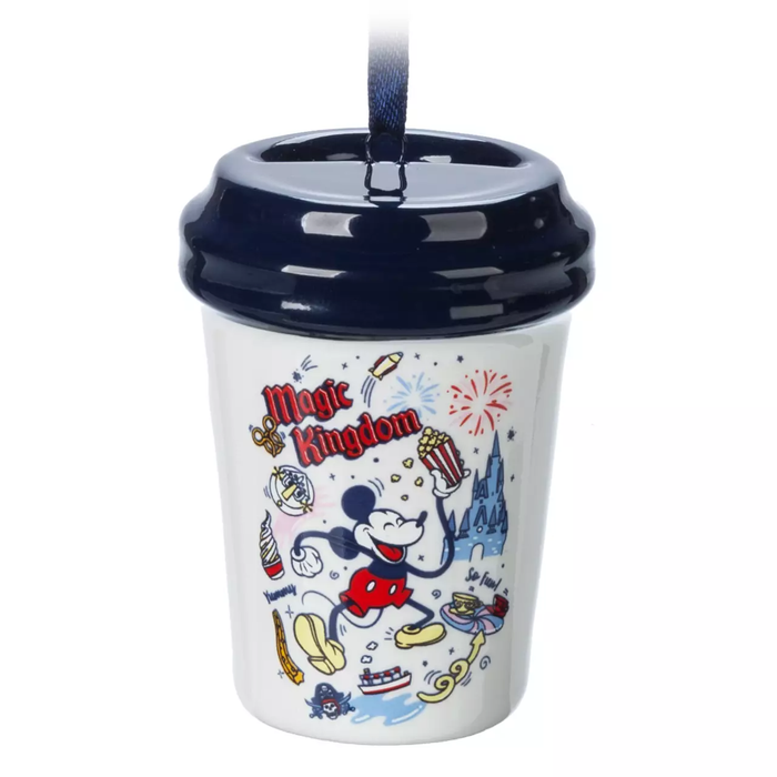 a coffee cup-shaped ornament with a Magic Kingdom design