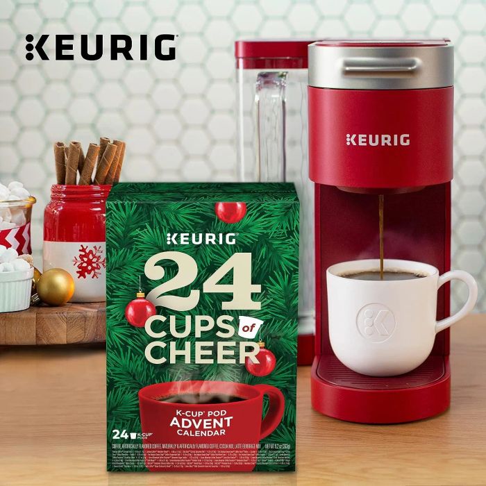 a red Keurig coffee machine paired with a 24 Cups of Cheer Advent calendar