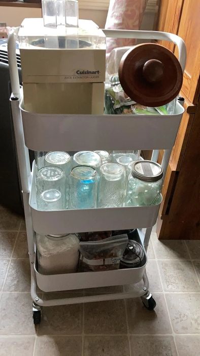 Reviewer photo of a kitchen cart filled with glass jars, a Cuisinart ice cream maker, and assorted pantry items on a tiled floor