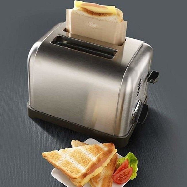 A sandwich tucked inside a bag, placed in a toaster.