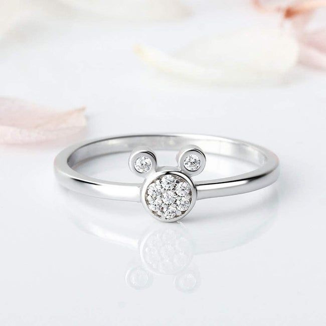 A silver ring featuring a cubic zirconia Mickey head at its center