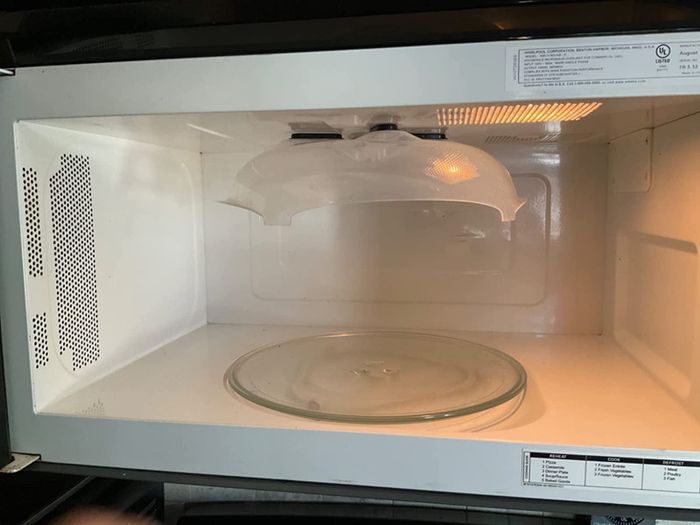 The splatter guard is securely attached to the top of the microwave
