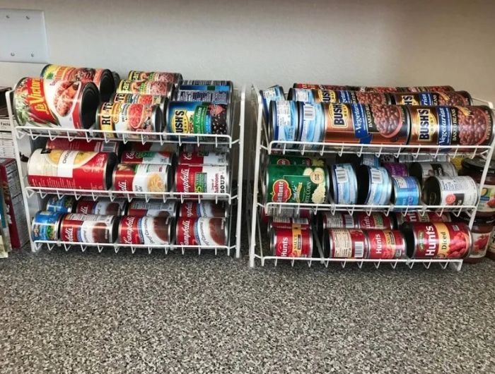 A white can organizer, filled with a colorful assortment of cans