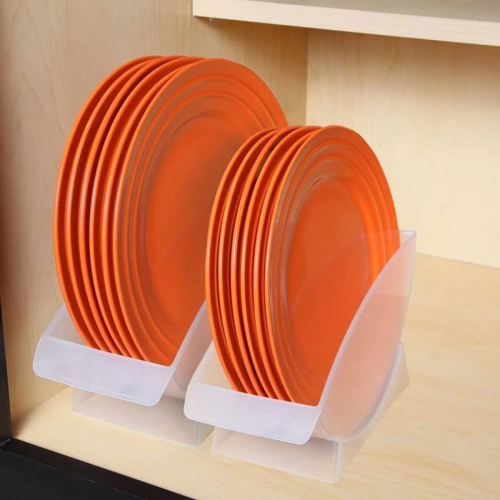 Two holders in a cabinet, one holding orange salad plates and the other dinner plates