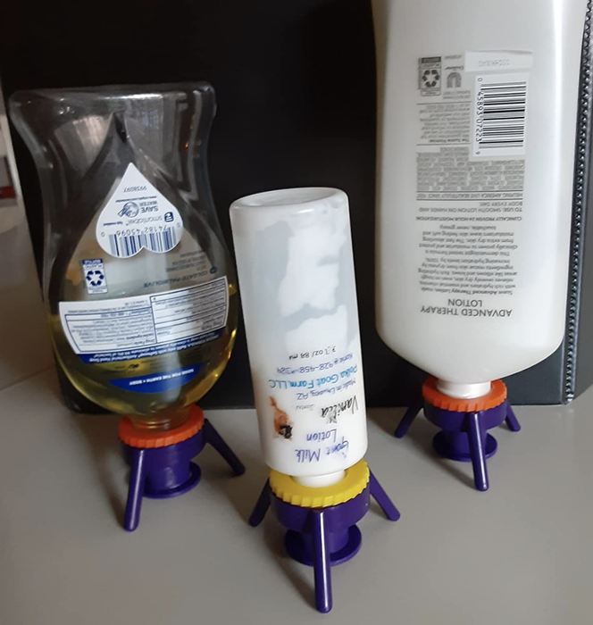 A customer review photo showing three bottles upside down, utilizing the Flip-It! system.