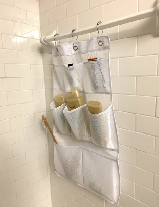 A customer review photo showcasing the shower curtain caddy