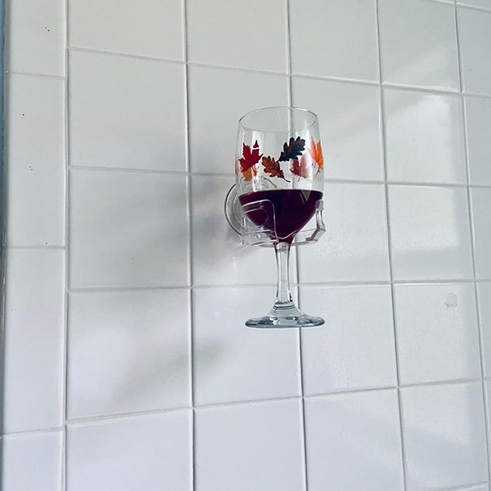 A reviewer’s photo showing the wine glass holder with a glass of red wine inside it