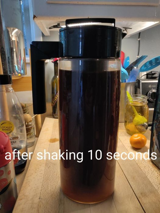 A post-shake photo of the cold brew maker, where the water has turned a rich dark brown after 10 seconds of shaking.